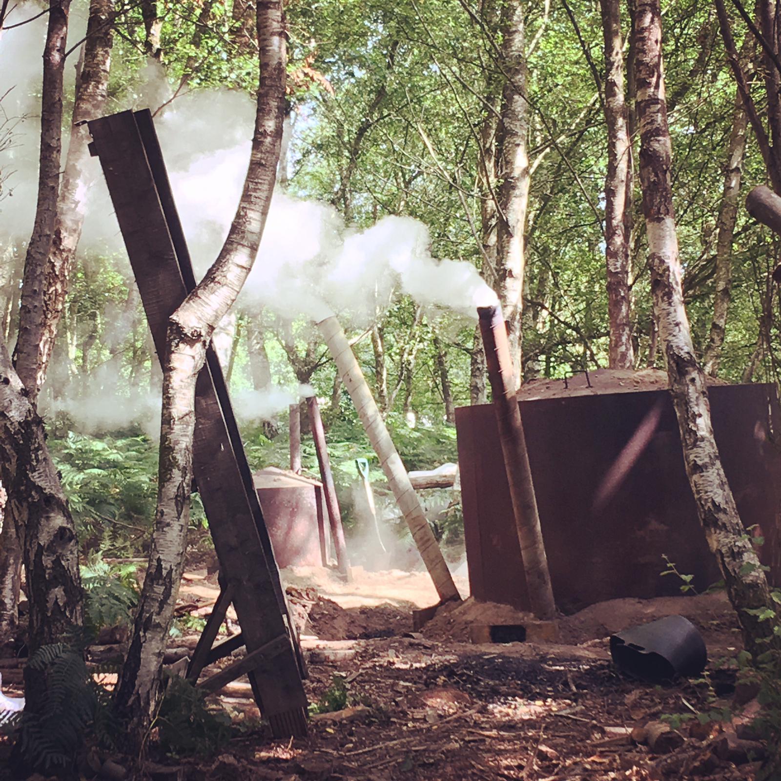 Charcoal making incinerator smoking in an area of Sussex Chestnut Coppice woodland