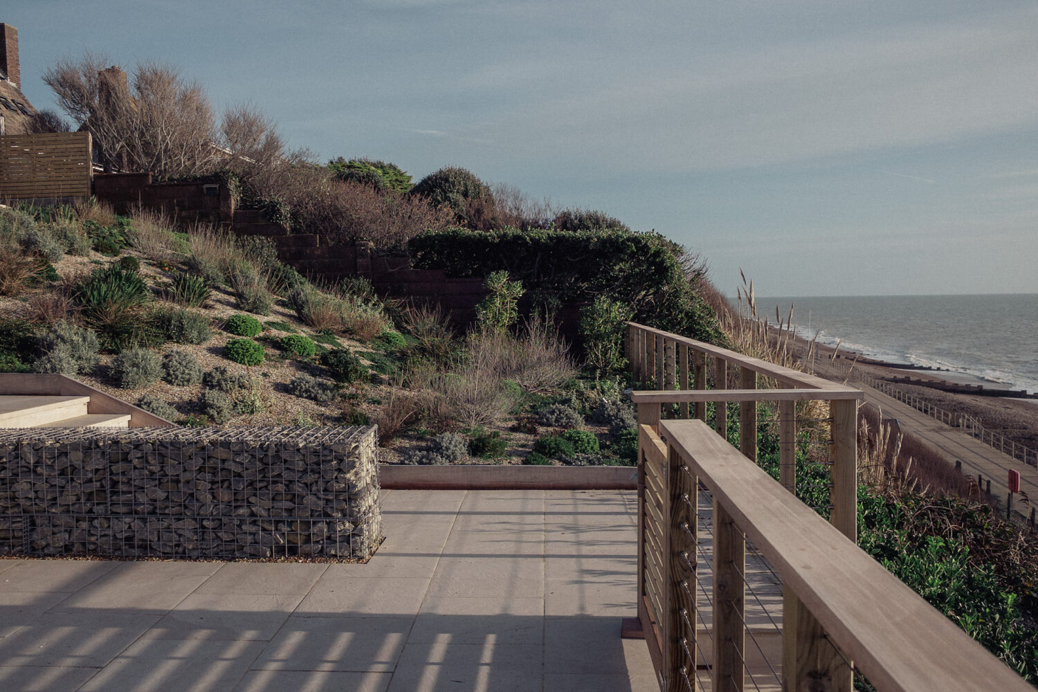 Stainless Steel wire fence with Red Grandis timber handrail overlooking the sea