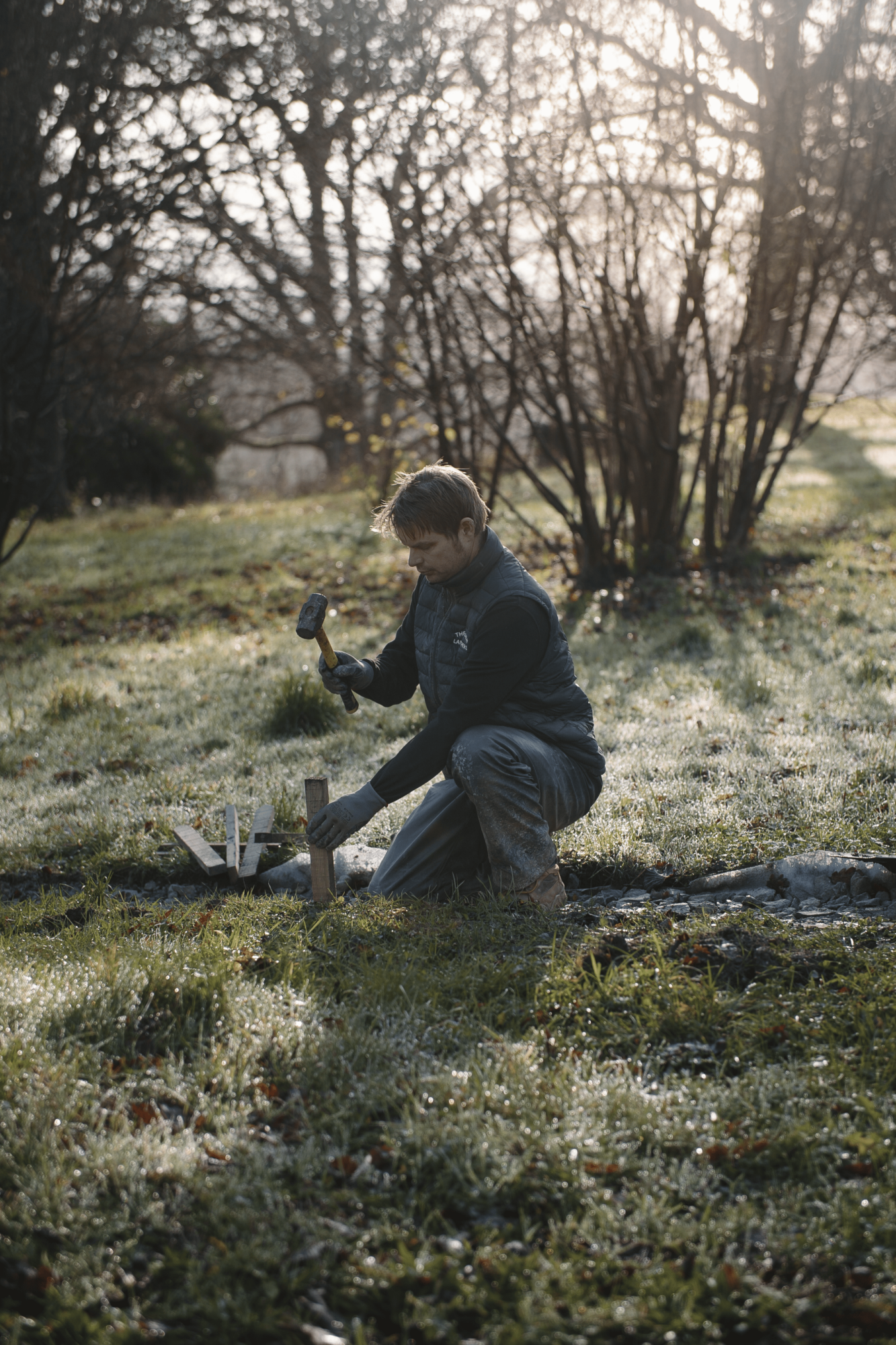 Skilled landscaper installing chestnut edging
